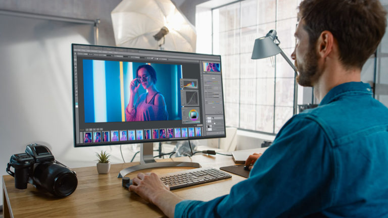 Photographer editing portrait in photoshop