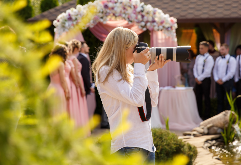 woman capturing wedding