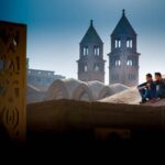 two guys sitting on rooftops