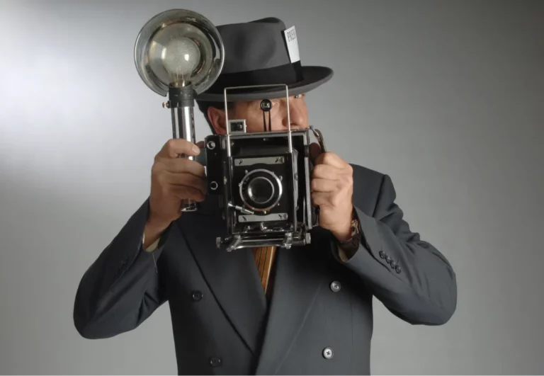 Retro photojournalist with old-time camera ready to take the perfect shot.