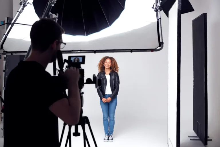 A photographer photographing a model in a studio.