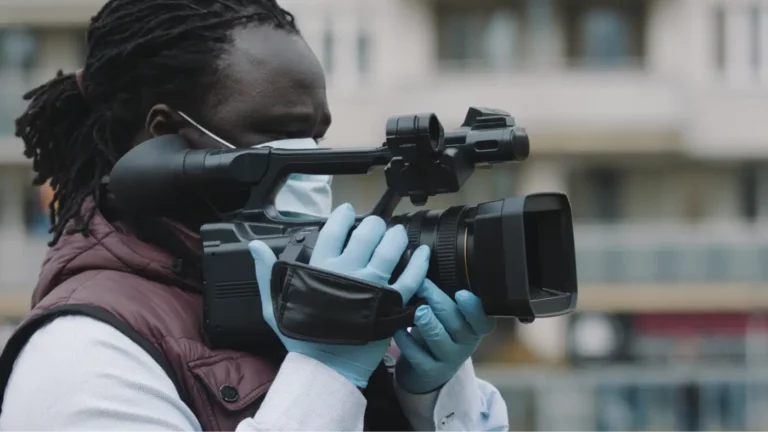 A man recording footage on his camera outside