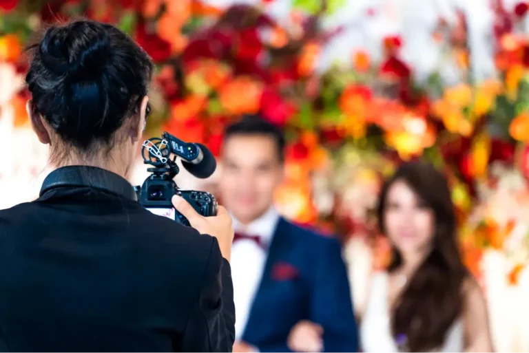 A videographer getting the perfect shot of newlyweds at a wedding