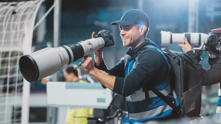 A sports photojournalist readies his camera for the game-winning shot.