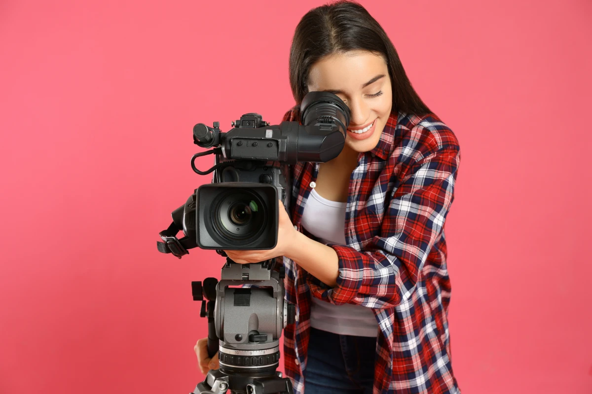 A videographer setting up the camera for a video shoot