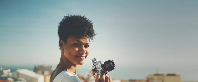 girl with camera smiling