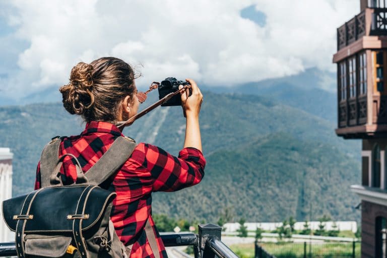 A woman taking photos of the mountain scenery